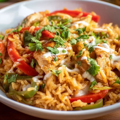 A plate of rice with chicken and peppers.