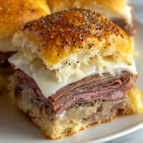 A plate of roast beef sliders on Hawaiian rolls.