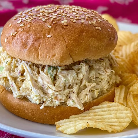 A sandwich with shredded chicken on a bun.