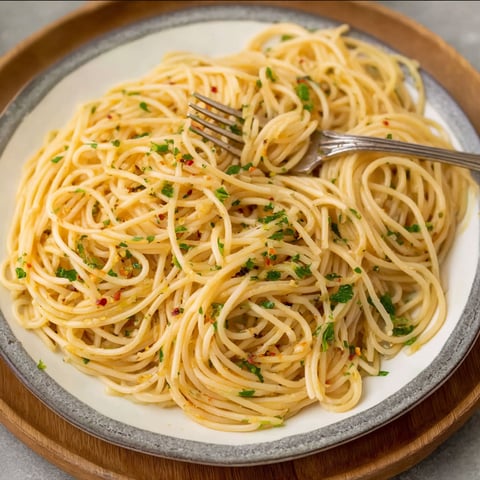 A plate of spaghetti with a fork on it.