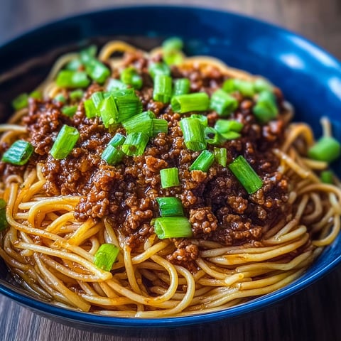 A bowl of Asian ground beef noodles.