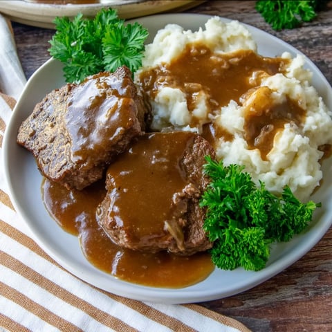 A plate of food with meat and potatoes.