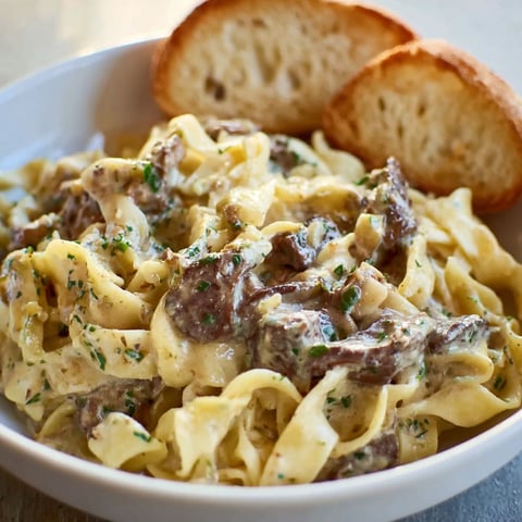 A bowl of beef and noodles.